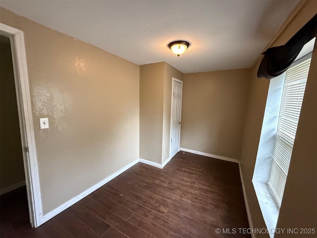 904 W Corporation St, Henryetta, OK 74437 - unfurnished room with dark wood-style floors and baseboards