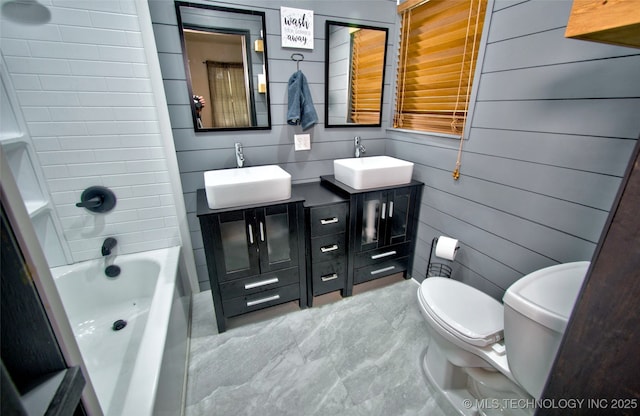 1424 E Okmulgee St, Muskogee, OK 74403 - full bathroom with double vanity, wooden walls, and tub / shower combination