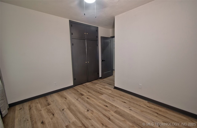 1424 E Okmulgee St, Muskogee, OK 74403 - unfurnished bedroom with light wood-style floors and a closet