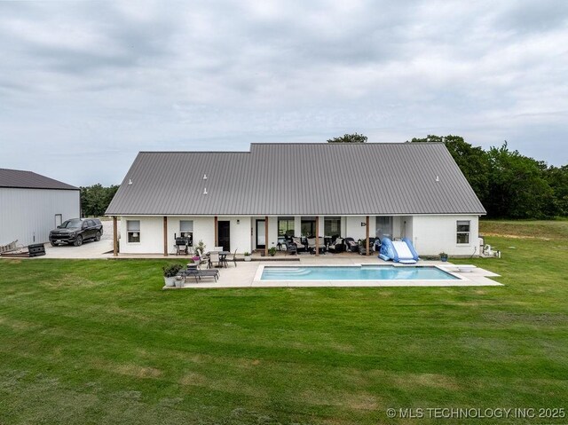 8486 Mcduffee Rd, Kingston, OK 73439 - rear view of property featuring a metal roof, a yard, and a patio area