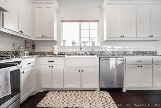 8486 Mcduffee Rd, Kingston, OK 73439 - kitchen featuring appliances with stainless steel finishes, backsplash, and white cabinetry