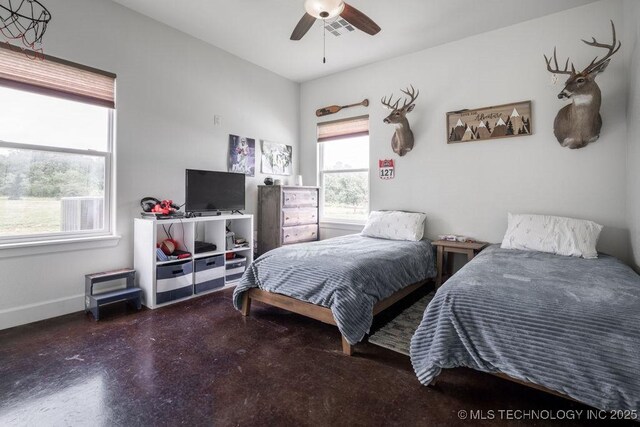 8486 Mcduffee Rd, Kingston, OK 73439 - bedroom with finished concrete floors and a ceiling fan