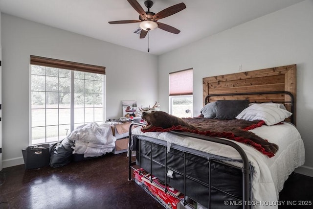 8486 Mcduffee Rd, Kingston, OK 73439 - bedroom with multiple windows, ceiling fan, and finished concrete floors