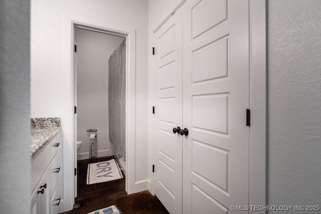 8486 Mcduffee Rd, Kingston, OK 73439 - bathroom with vanity, wood finished floors, and curtained shower
