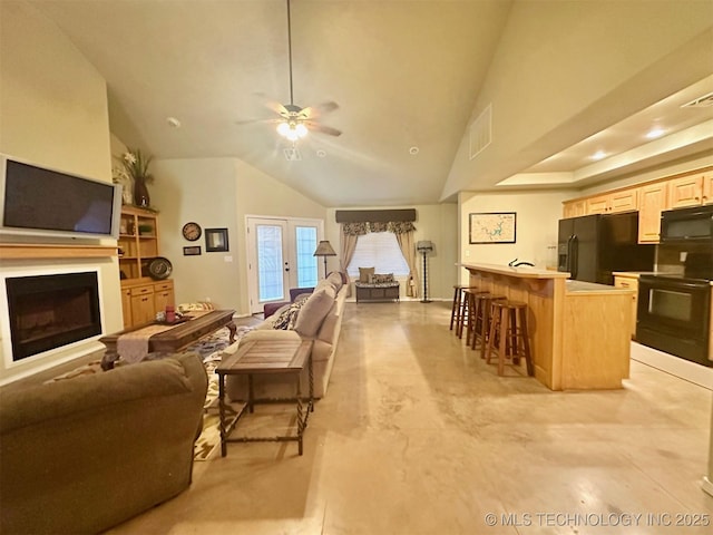 1908 Rhynes-Childress Loop, Kingston, OK 73439 - living area with ceiling fan, lofted ceiling, a fireplace, concrete floors, and french doors