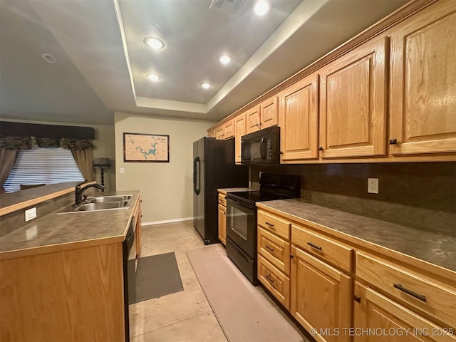 1908 Rhynes-Childress Loop, Kingston, OK 73439 - kitchen with black appliances, a tray ceiling, recessed lighting, dark countertops, and light tile patterned floors