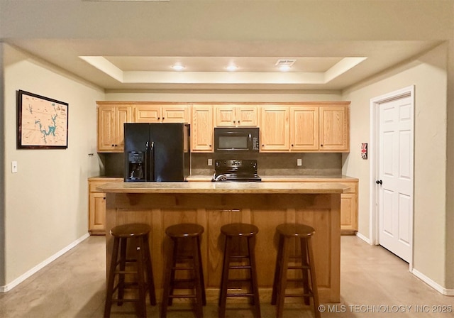 1908 Rhynes-Childress Loop, Kingston, OK 73439 - kitchen featuring black appliances, light brown cabinetry, and a raised ceiling