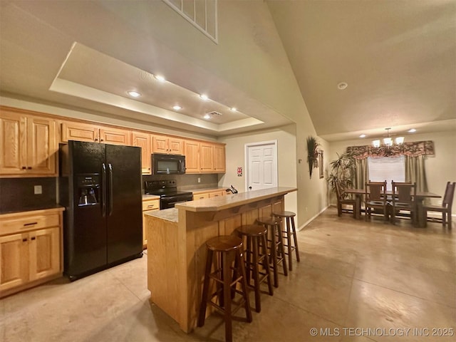 1908 Rhynes-Childress Loop, Kingston, OK 73439 - kitchen featuring black appliances, a breakfast bar, an island with sink, light brown cabinets, and recessed lighting