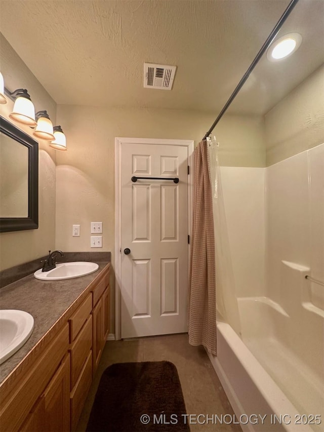 1908 Rhynes-Childress Loop, Kingston, OK 73439 - full bathroom featuring shower / tub combo with curtain, double vanity, and a textured ceiling