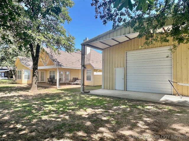 1908 Rhynes-Childress Loop, Kingston, OK 73439 - rear view of property featuring a garage and a patio area