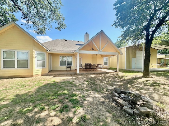 1908 Rhynes-Childress Loop, Kingston, OK 73439 - back of house featuring a chimney, an outdoor fire pit, a patio area, and a ceiling fan