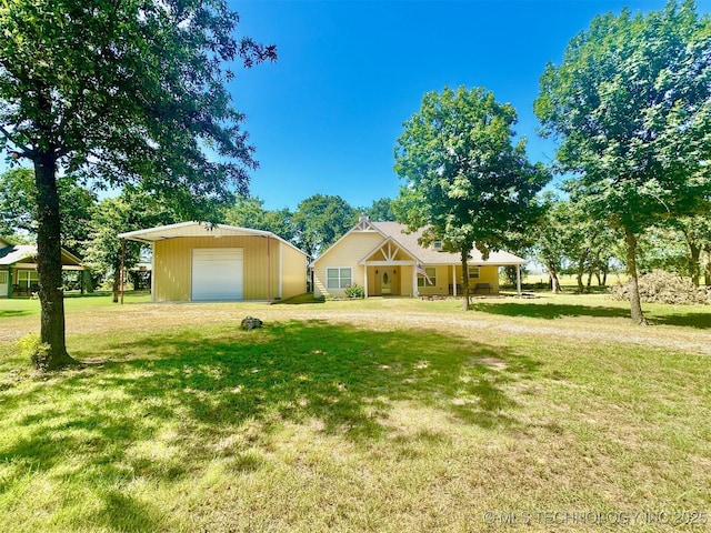 1908 Rhynes-Childress Loop, Kingston, OK 73439 - view of front facade featuring a detached garage, a front yard, an outdoor structure, and dirt driveway