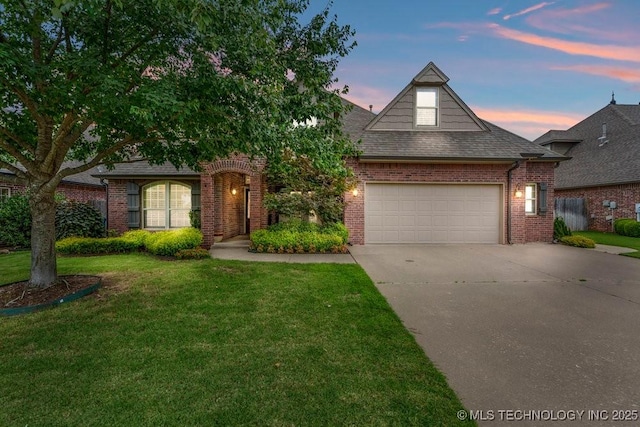 14404 S Florence Ave, Bixby, OK 74008 - view of front of property featuring concrete driveway, brick siding, a yard, a garage, and roof with shingles