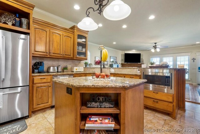 14404 S Florence Ave, Bixby, OK 74008 - kitchen featuring stainless steel appliances, open shelves, crown molding, a center island, and brown cabinets