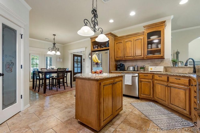 14404 S Florence Ave, Bixby, OK 74008 - kitchen featuring appliances with stainless steel finishes, brown cabinetry, a kitchen island, tasteful backsplash, and recessed lighting