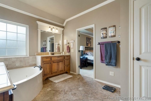 14404 S Florence Ave, Bixby, OK 74008 - ensuite bathroom featuring a jetted tub, vanity, ornamental molding, and tile patterned floors