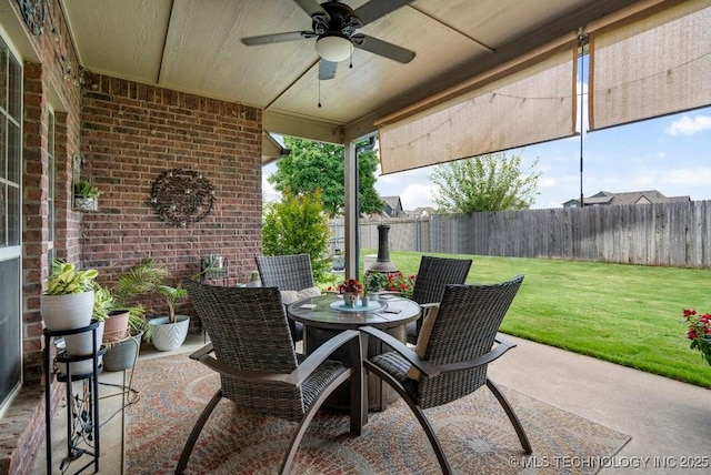 14404 S Florence Ave, Bixby, OK 74008 - fenced backyard featuring a ceiling fan, outdoor dining space, and a patio