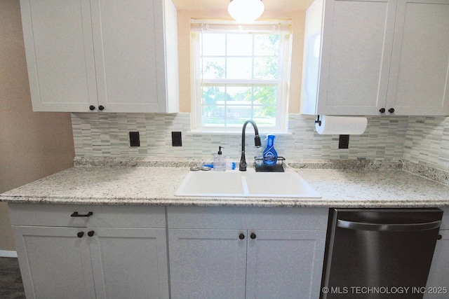 1518 E Hogner St, Tahlequah, OK 74464 - kitchen featuring dishwasher, decorative backsplash, light countertops, and white cabinets