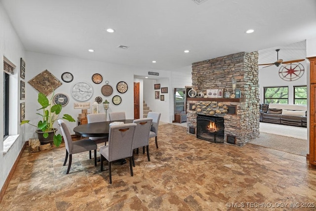 9094 Waters Edge, Kingston, OK 73439 - dining area featuring a stone fireplace, recessed lighting, a ceiling fan, stairway, and stone finish flooring