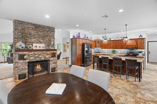 9094 Waters Edge, Kingston, OK 73439 - dining room with a stone fireplace and recessed lighting