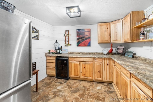 9094 Waters Edge, Kingston, OK 73439 - kitchen featuring freestanding refrigerator, wine cooler, open shelves, stone finish floors, and a textured ceiling