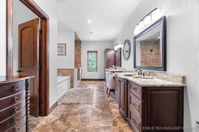 9094 Waters Edge, Kingston, OK 73439 - full bathroom with vanity, a garden tub, and stone finish floors