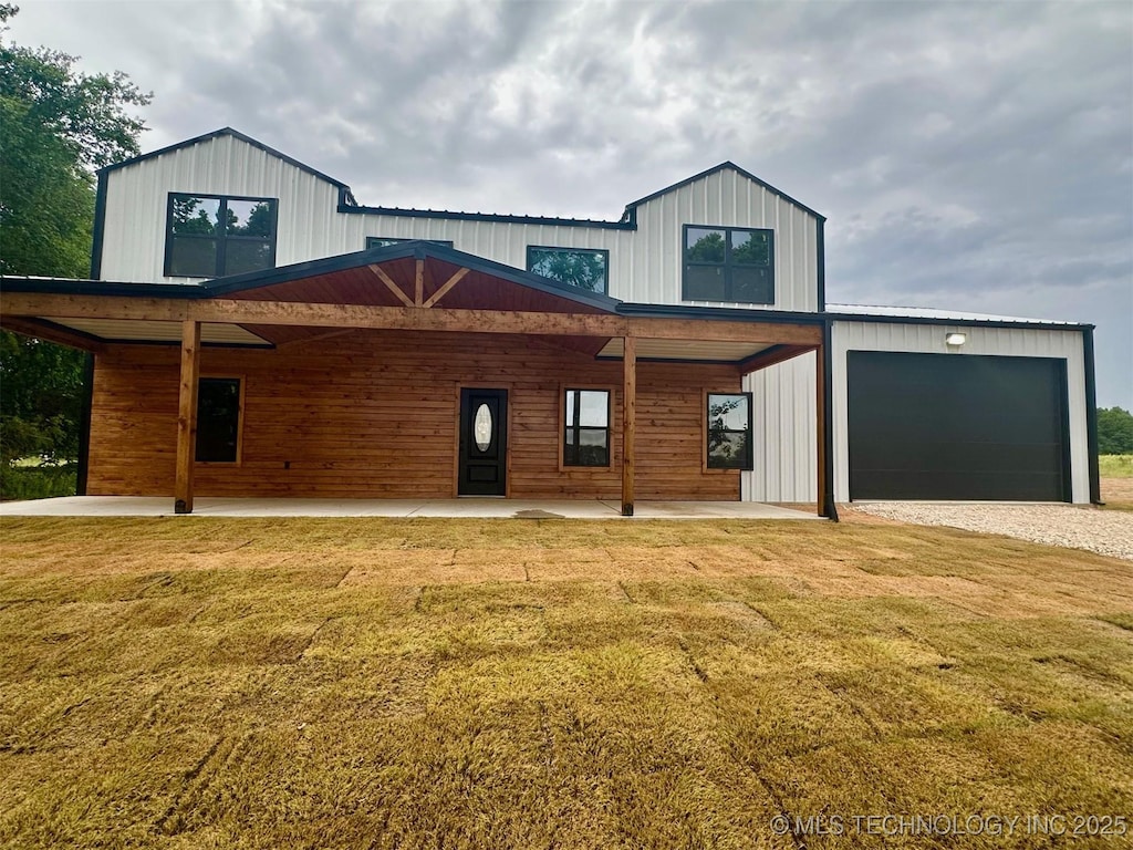 11743 Xander Ln, Kingston, OK 73439 - modern farmhouse featuring a front lawn and an attached garage