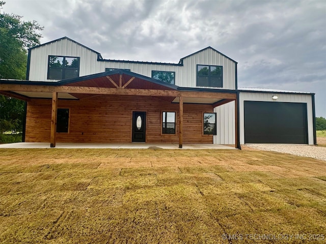 11743 Xander Ln, Kingston, OK 73439 - modern farmhouse featuring a front lawn and an attached garage