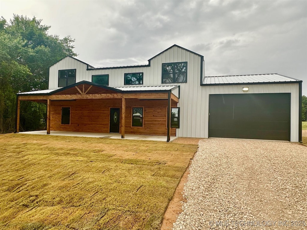 11743 Xander Ln, Kingston, OK 73439 - modern inspired farmhouse with driveway, a front yard, a garage, and a metal roof
