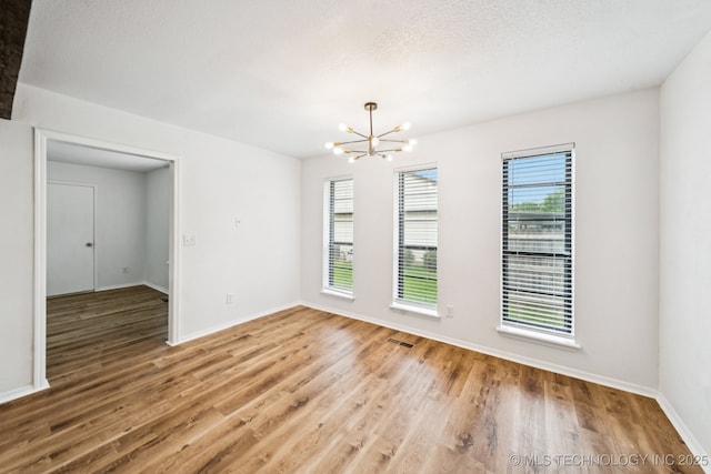 6947 S 30th W Ave, Tulsa, OK 74132 - empty room featuring a chandelier and wood finished floors