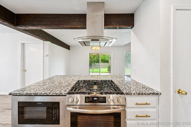 6947 S 30th W Ave, Tulsa, OK 74132 - kitchen with stainless steel gas range, island exhaust hood, built in microwave, light stone counters, and white cabinets