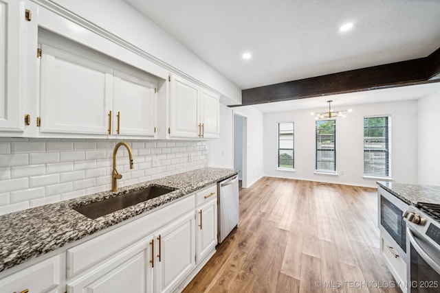 6947 S 30th W Ave, Tulsa, OK 74132 - kitchen featuring appliances with stainless steel finishes, backsplash, light wood-type flooring, white cabinets, and dark stone counters