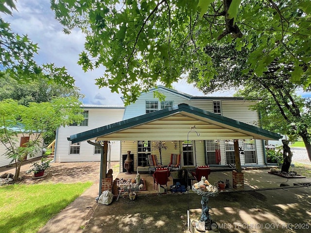 98224 S 4489th Rd, Vian, OK 74962 - view of front facade featuring covered porch and a detached carport