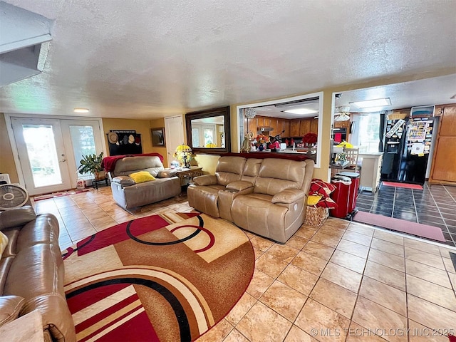 98224 S 4489th Rd, Vian, OK 74962 - living area featuring a textured ceiling, light tile patterned flooring, and plenty of natural light