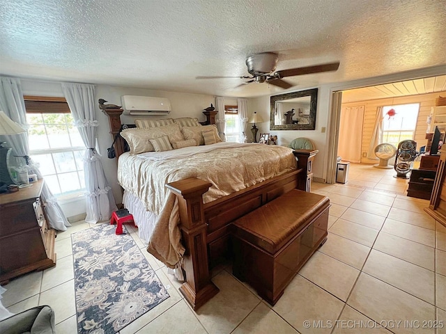 98224 S 4489th Rd, Vian, OK 74962 - bedroom with a wall mounted air conditioner, multiple windows, light tile patterned floors, and a textured ceiling