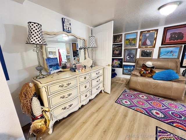 98224 S 4489th Rd, Vian, OK 74962 - bedroom featuring light wood finished floors and a textured ceiling