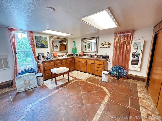 98224 S 4489th Rd, Vian, OK 74962 - bathroom featuring double vanity, inlaid floor details, and tile patterned floors