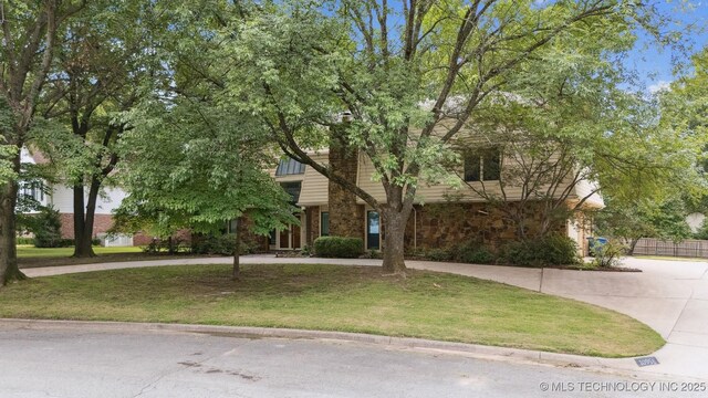 10958 S Richmond Ave, Tulsa, OK 74137 - obstructed view of property featuring stone siding