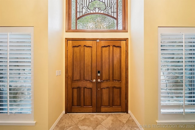 10958 S Richmond Ave, Tulsa, OK 74137 - entryway with baseboards and light tile patterned floors