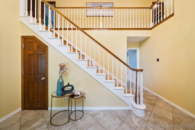 10958 S Richmond Ave, Tulsa, OK 74137 - stairs featuring baseboards and a high ceiling
