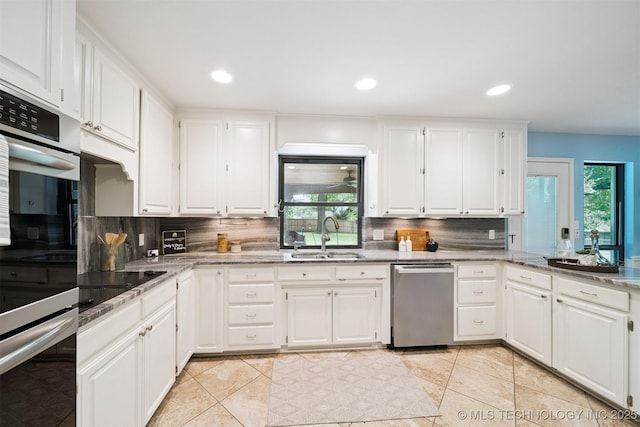 10958 S Richmond Ave, Tulsa, OK 74137 - kitchen with appliances with stainless steel finishes, decorative backsplash, white cabinets, and recessed lighting