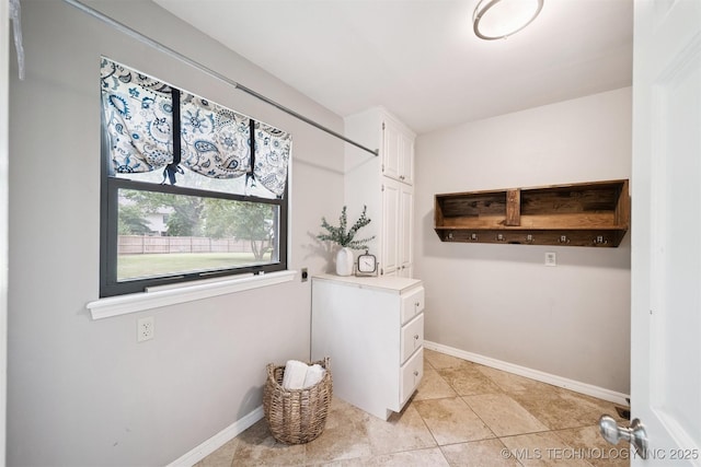 10958 S Richmond Ave, Tulsa, OK 74137 - washroom with baseboards and light tile patterned flooring