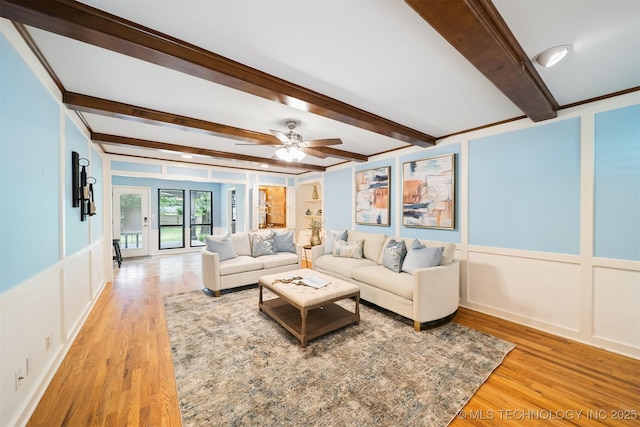 10958 S Richmond Ave, Tulsa, OK 74137 - living area featuring a decorative wall, light wood-style floors, beamed ceiling, a ceiling fan, and wainscoting