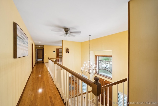 10958 S Richmond Ave, Tulsa, OK 74137 - hallway with an upstairs landing, a chandelier, and wood-type flooring
