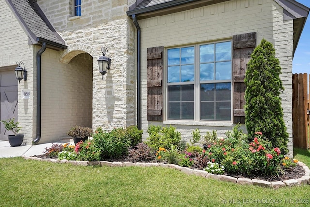 14505 E 79th St, Owasso, OK 74055 - view of exterior entry with stone siding and a lawn
