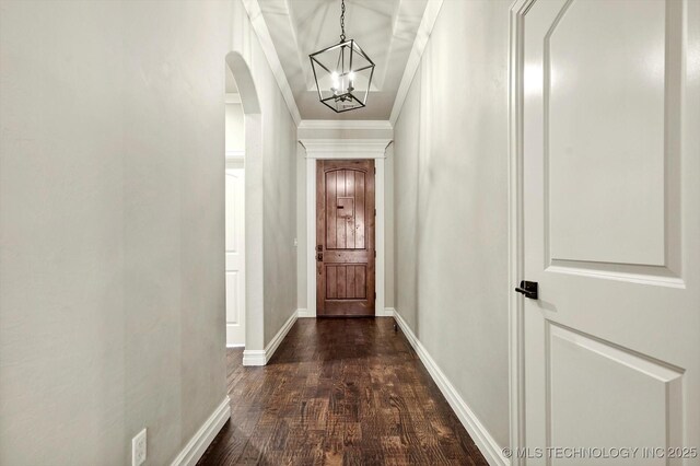 14505 E 79th St, Owasso, OK 74055 - entryway featuring arched walkways, a chandelier, dark wood-style floors, and ornamental molding