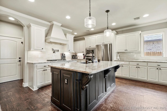 14505 E 79th St, Owasso, OK 74055 - kitchen with custom range hood, stainless steel appliances, white cabinets, recessed lighting, and ornamental molding