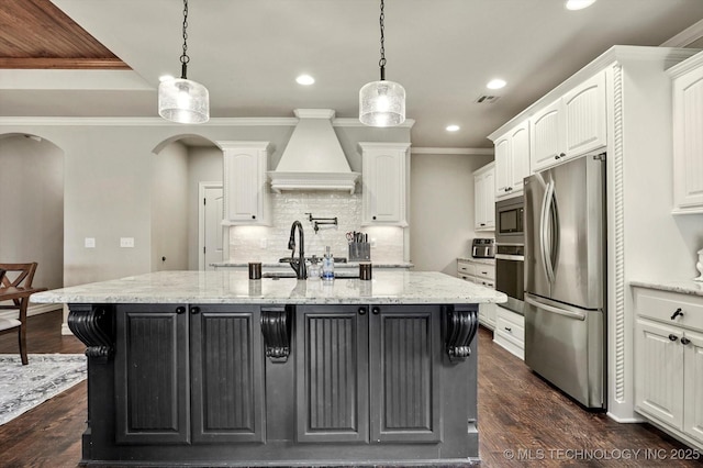 14505 E 79th St, Owasso, OK 74055 - kitchen featuring stainless steel appliances, custom range hood, white cabinets, recessed lighting, and decorative backsplash