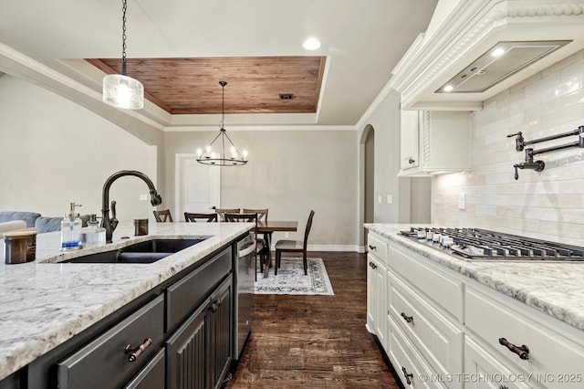 14505 E 79th St, Owasso, OK 74055 - kitchen with stainless steel appliances, arched walkways, custom range hood, white cabinetry, and decorative backsplash