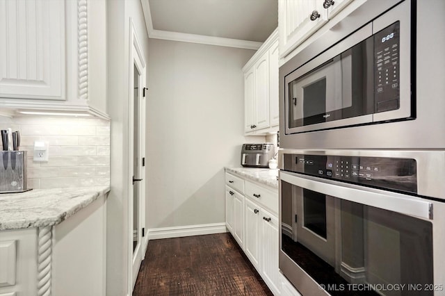14505 E 79th St, Owasso, OK 74055 - kitchen featuring appliances with stainless steel finishes, crown molding, backsplash, white cabinets, and dark wood-style flooring